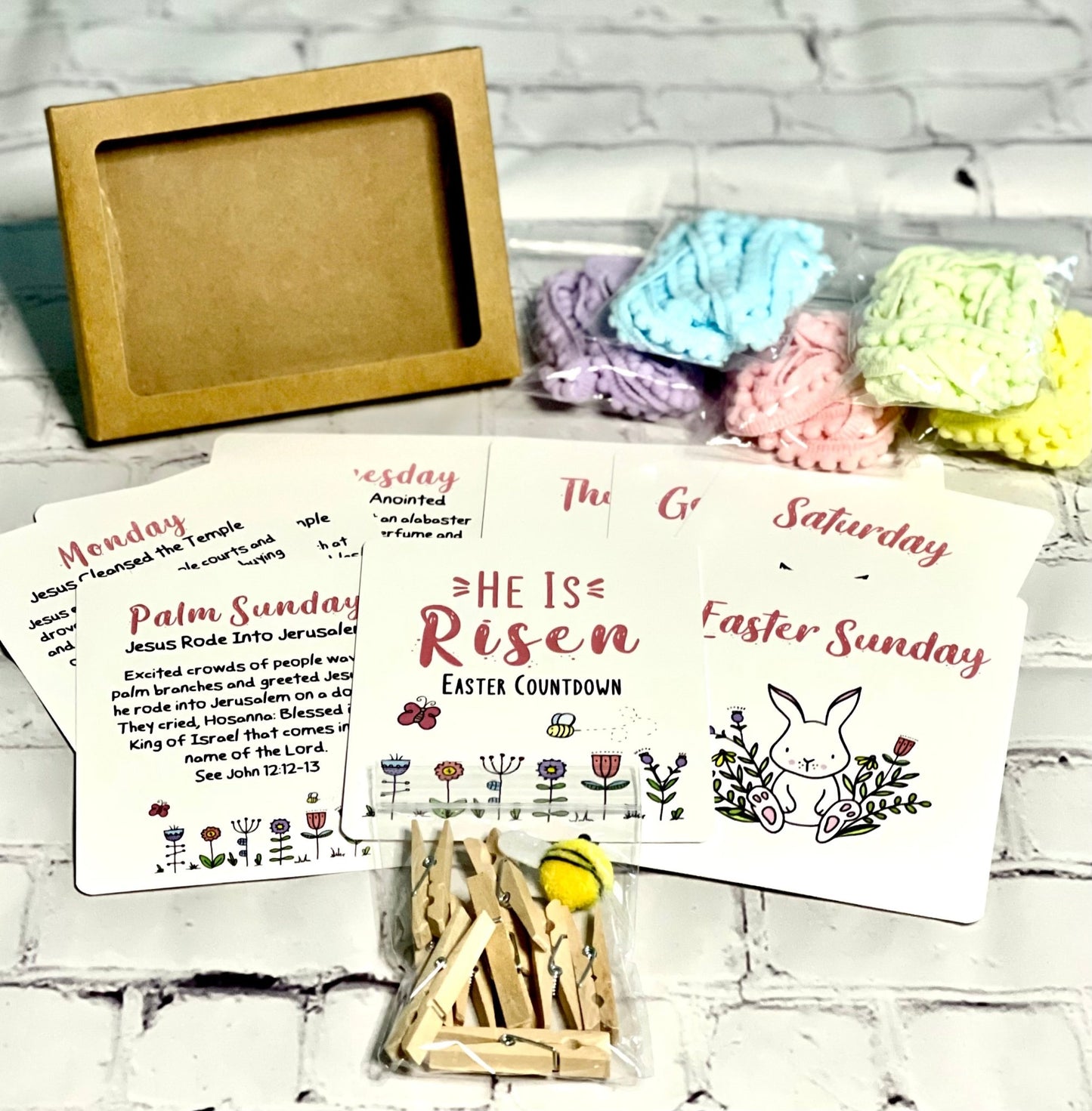 HE IS RISEN EASTER COUNTDOWN BOXED SET (includes 9 premium cards, Pom Pom trim, clothespins, and fuzzy bumblebee)